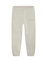 Load image into Gallery viewer, NORR Daisy sweat pants have a relaxed fit and tapered leg, with elastic in waist and hem. There is a subtle logo print on the front leg. Cotton